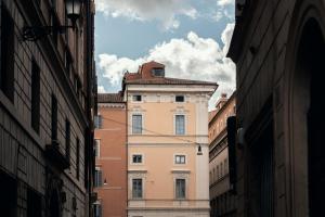 a building in an alley between two buildings at Velvet Grey Boutique Hotel Roma in Rome