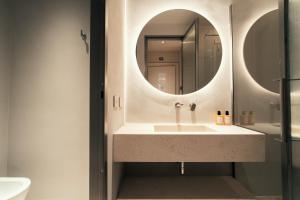 a bathroom with a sink and a mirror at Velvet Grey Boutique Hotel Roma in Rome