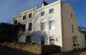 a white building with a fence in front of it at Belvedere Lodge Swanage Dorset Sea View Luxury in Swanage
