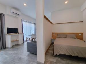 a bedroom with a bed and a desk and a television at La Cittadella ex WAVA Spa in Brugnato