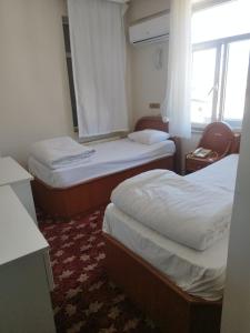 Postel nebo postele na pokoji v ubytování Hotel Birkent
