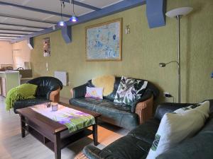 a living room with two couches and a coffee table at Ferienhaus ODIN in Großräschen +11 photos