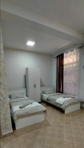 a room with two beds and a window at Apartman SPLENDID in Kladovo