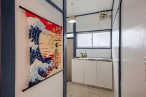 a bathroom with a painting of a wave on the wall at Central Panda Hotel in Tokyo +74 photos