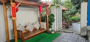 a porch with a wooden bench with chinese decorations at Khách sạn 25 tháng 12 - Tánh Linh in Tánh Linh
