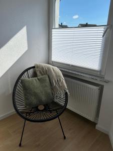 a chair with a pillow in a room with a window at RheinSchatz Apartments 6 in Oberwesel