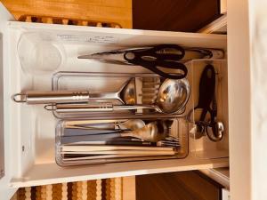 a drawer in a kitchen with utensils in it at Raffine103 in Sapporo