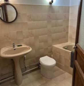 a bathroom with a sink and a toilet and a mirror at centre ville2 in Marignane