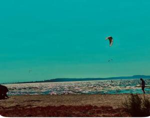 a person is flying a kite on the beach at centre ville2 in Marignane