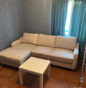 a living room with a white couch and a table at centre ville2 in Marignane