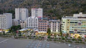 a group of buildings in a city with a parking lot at Hotel Besa in Shëngjin