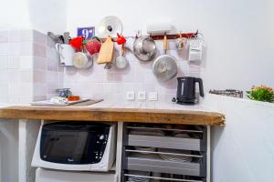 a kitchen with a counter top with a microwave at Le petit carnot in Apt +1 photo