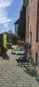 a bench sitting in front of a brick building at Rheinufer in Xanten