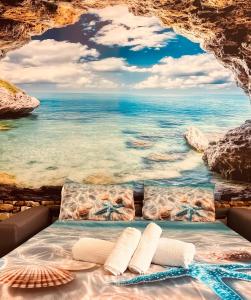 a bed with a view of the ocean at The square in Orosei
