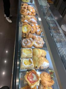 a display case with many different types of pastries at camiBB in Castel del Rio