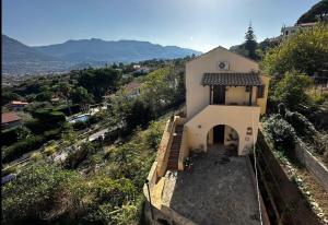 a small white church on a hill with a view at Casale di Sicilia in Monreale