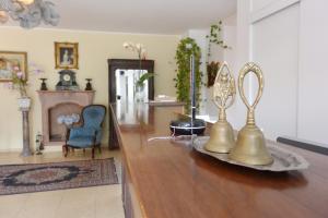 ein Wohnzimmer mit einem Tisch mit zwei Glocken darauf in der Unterkunft Hotel Ristorante Italia in Certosa di Pavia