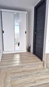 a room with a large door and a wooden floor at Serendipia 52 in Suances