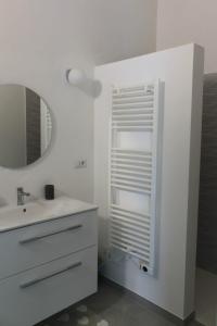 a bathroom with a sink and a mirror at Rdm affittacamere in Albiano +55 photos