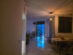 a living room with a table and a dining room at חלום מול נוף הכנרת in Tiberias