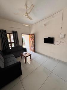 a living room with a couch and a table at Sree Shivanya Homes in Trivandrum