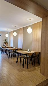 a row of tables and chairs in a room with lights at Motel Domowy Gościniec in Łomża