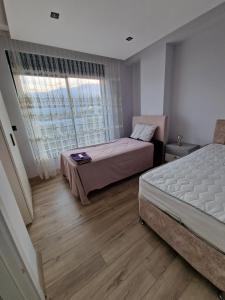 ein Schlafzimmer mit zwei Betten und einem Fenster in der Unterkunft Golden Life Family Villa 2 in Dosemealti + 24 Fotos