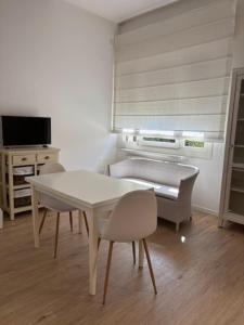 a living room with a white table and chairs at Bianca's home in Cavallino-Treporti