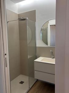 a bathroom with a shower and a sink and a mirror at Bianca's home in Cavallino-Treporti +2 photos