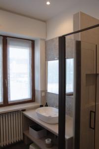 a bathroom with a sink and a glass shower at Blue Apartment - Verona&Lake in Bussolengo +19 photos