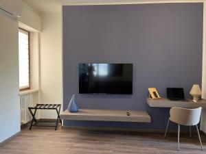 a living room with a flat screen tv on a wall at Blue Apartment - Verona&Lake in Bussolengo