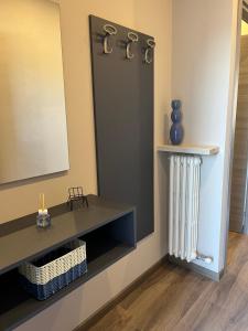 a dressing room with a mirror and a radiator at Blue Apartment - Verona&Lake in Bussolengo
