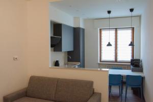 a living room with a couch and a table at Blue Apartment - Verona&Lake in Bussolengo