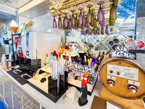 a coffee shop with a counter with many different items at Hotel BaliBali 熊本 in Kumamoto