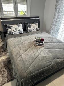 a bed with a tray with a flower on it at 4SeasonsApartment in Kardítsa