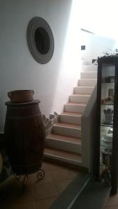 a set of stairs in a room with a pot at Bed and Breakfast Villa Angelina in Lipari