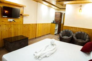 a room with a white towel on a table at Sparkle Heights in Mussoorie