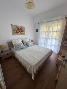 a bedroom with a large bed and a window at Ana Maria Boutique House in Samothráki +74 photos