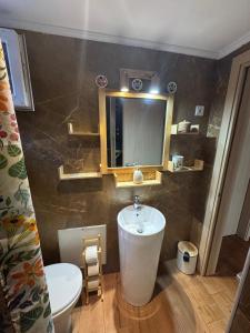 a bathroom with a sink and a toilet and a mirror at Ana Maria Boutique House in Samothraki +74 photos