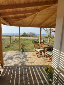 a patio with two chairs and a table with a view of the ocean at Ana Maria Boutique House in Samothráki