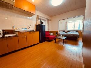 a room with a kitchen and a living room at Choyo 105 in Sapporo
