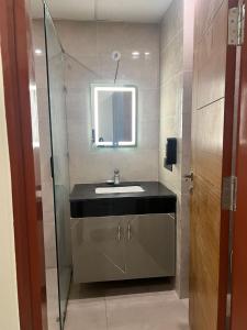 a bathroom with a sink and a mirror at Celestia hotel in Uttar Pradesh