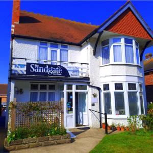 a white building with a sign that reads the santanderarma at The Sandgate in Skegness