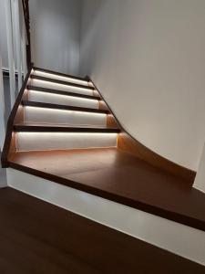 a staircase in a house with wooden flooring and wooden steps at Casa Peña in Hinojedo +10 photos