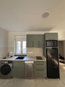 a kitchen with a stainless steel refrigerator and appliances at Casa Peña in Hinojedo