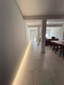 a hallway with a table and a dining room at Casa Peña in Hinojedo