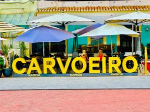 a group of umbrellas sitting in front of a restaurant at Luisela Mar Algarve in Carvoeiro