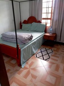 a bedroom with a bed with a canopy at Makinihomestay in Arusha +4 photos
