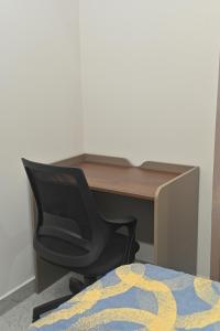 a desk with a chair in front of a desk at 1 BHK Penthouse Fully Furnished with Lift Access #602 in Kondapur