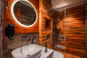 a bathroom with a sink and a mirror and a shower at Indulge McLeodganj by Pack in McLeod Ganj +38 photos